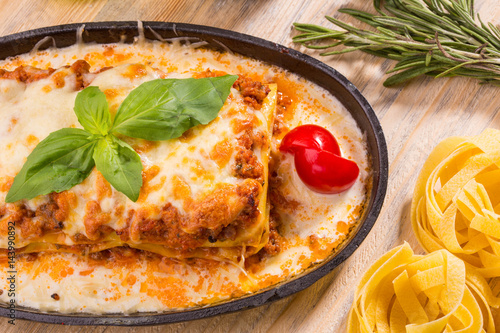 Thin sheets of paste with forcemeat from beef with tomato sauce photo