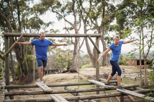 Fit man and woman during obstacle course training