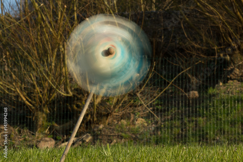 Pinwheel kids windmill swivel fast blown by the wind on a green garden