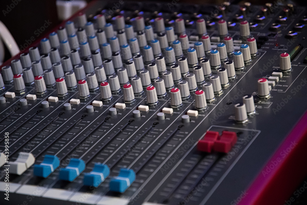 Fototapeta premium Sound mixer. Professional audio mixing console with lights, buttons, faders and sliders.