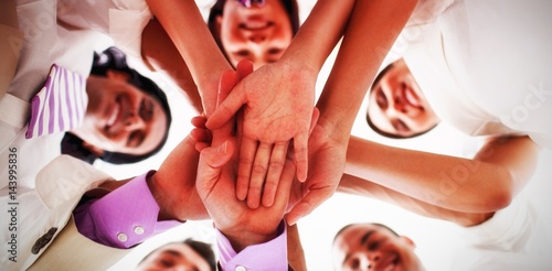 Portrait of business team stacking hands