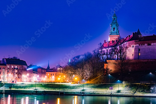 Royal castle of the Polish kings on the Wawel hill, over the Vistula river in the evening, Krakow, Poland photo