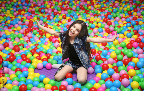 Cute girl playing with plastic balls