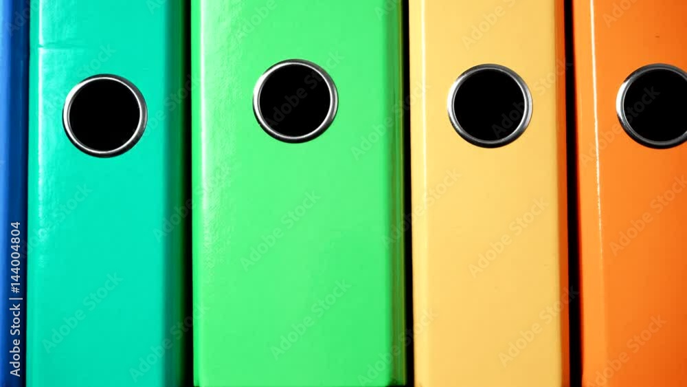 Close up of many colorful file folders, ring binders as vivid color office background. Dolly slider shot 4K ProRes HQ codec Close up of many colorful file folders, ring binders as vivid color office background. Dolly slider shot 4K ProRes HQ codec