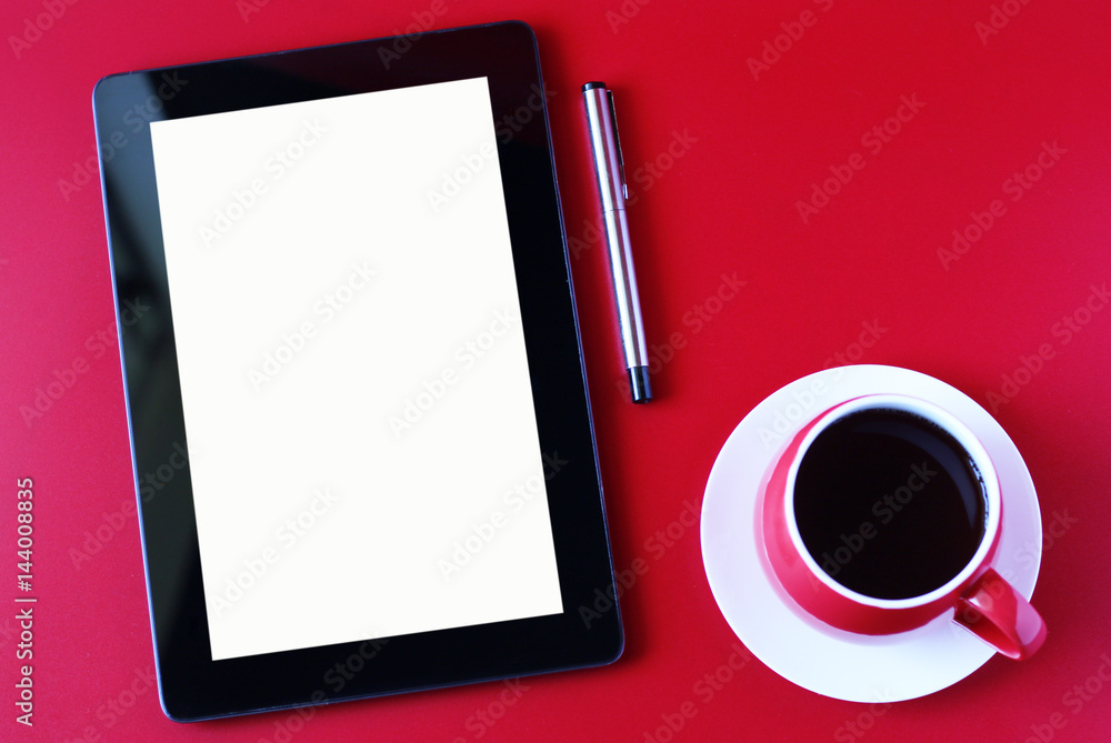 Workspace, tablet and coffee cup on red table. Workspace, tablet and coffee cup on red table.
