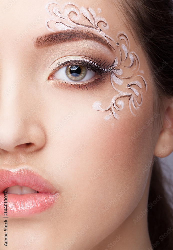 Φωτογραφία Close-up portrait of young woman with face art  make up
