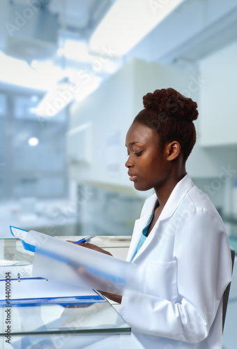 African-american biologist checks sequencing results in scientific lab or research facility photo