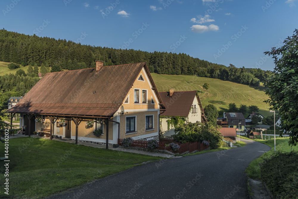 Sunny summer day in Krkonose mountains with countryside house