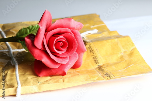Used brown color document paper envelop in the scene appear the artificial flower on the envelope also represent the business concept idea.