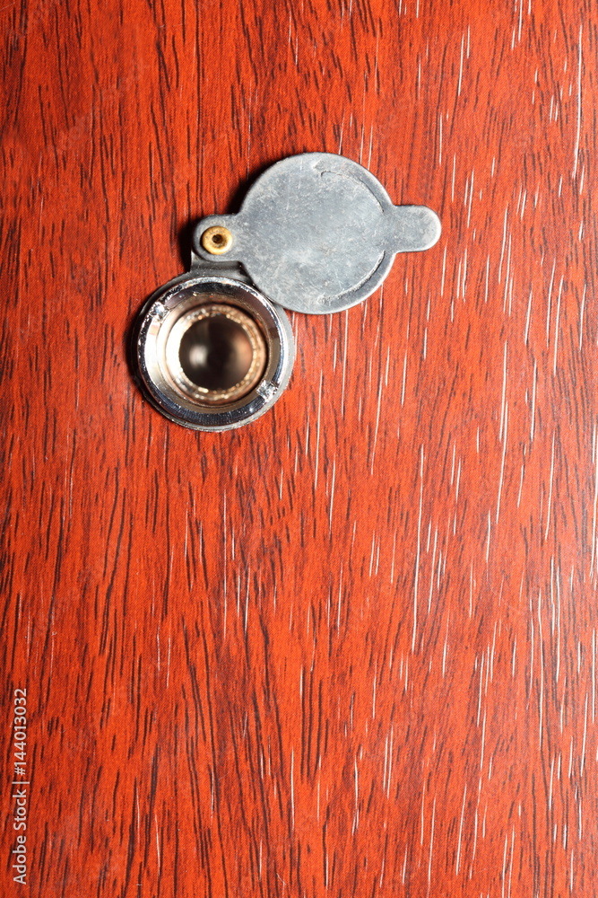 Peephole on wooden door Peephole on wooden door