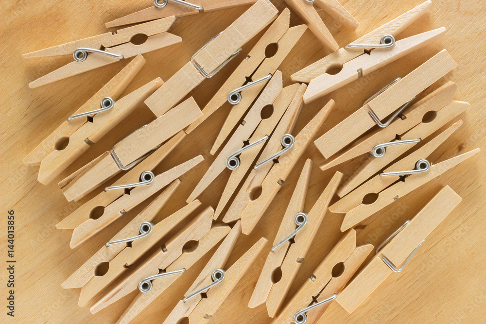 The background of a number of wooden clothespins on a table The background of a number of wooden clothespins on a table
