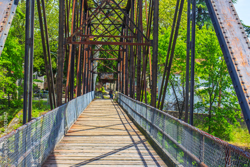 Fototapeta Naklejka Na Ścianę i Meble -  Iron & Wood Walking Bridge Over Creek