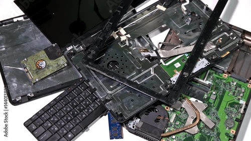 Broken laptop lies on a white table