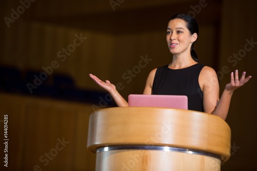 Female business executive giving a speech photo