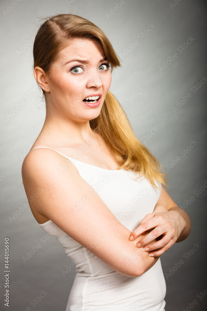 woman scratching her itchy arm with allergy rash woman scratching her itchy arm with allergy rash