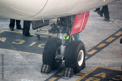 Close-up of airplane wheels in runway.