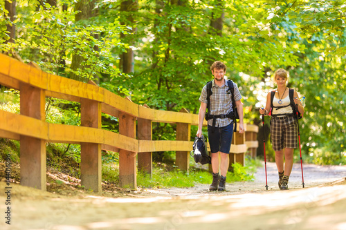Fototapeta Naklejka Na Ścianę i Meble -  couple backpacker hiking in forest pathway