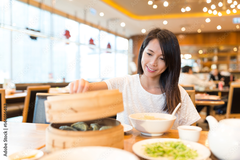 Woman having food in chinese restaurant