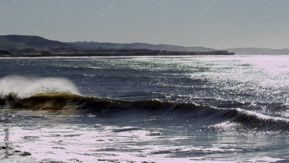 Amazing waves of the ocean are beating against the shore