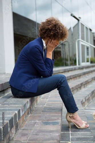 Depressed businesswoman sitting in the premises © WavebreakMediaMicro