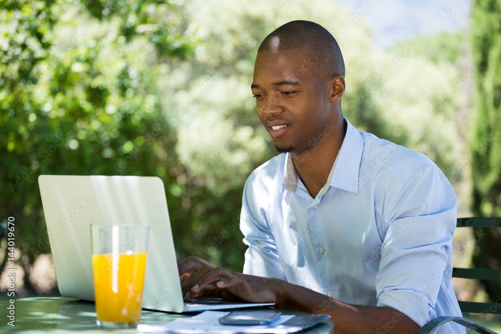 Businessman using laptop at restaurant Businessman using laptop at restaurant