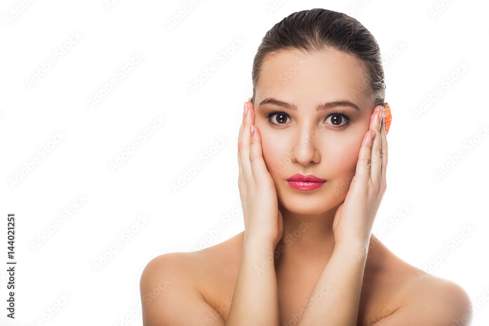 Fototapeta premium beautiful girl with clean skin natural gentle refreshing makeup on a white background isolate hands on face looking at the camera Spa treatment