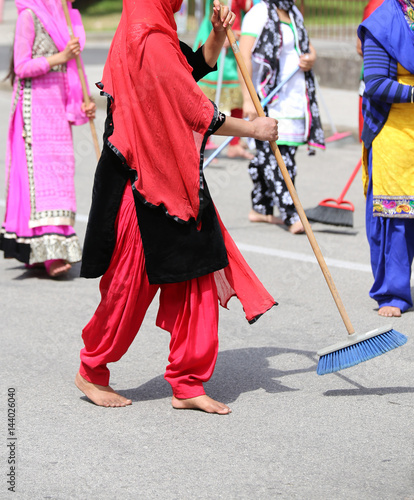 many Sikhs women barefoot while scavenging the road during a Si