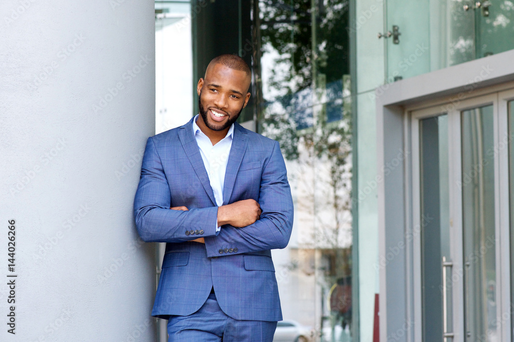 handsome smiling businessman leaning against wall outdoors handsome smiling businessman leaning against wall outdoors