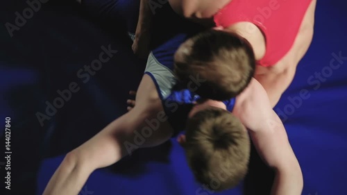 two wrestlers Greco-Roman wrestling on the blue background slow mo