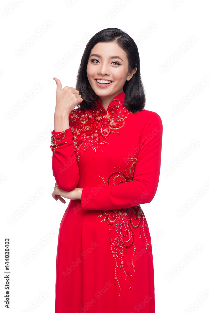 Charming Vietnamese Woman in Red Ao Dai Traditional Dress. gesture good sign. Charming Vietnamese Woman in Red Ao Dai Traditional Dress. gesture good sign.