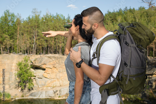 Tableau sur toile Happy young couple enjoying the hike in the woods