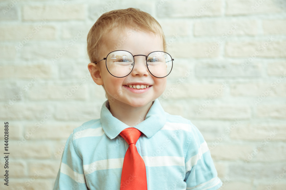Little smiling boy with the big glasses and red tie Little smiling boy with the big glasses and red tie