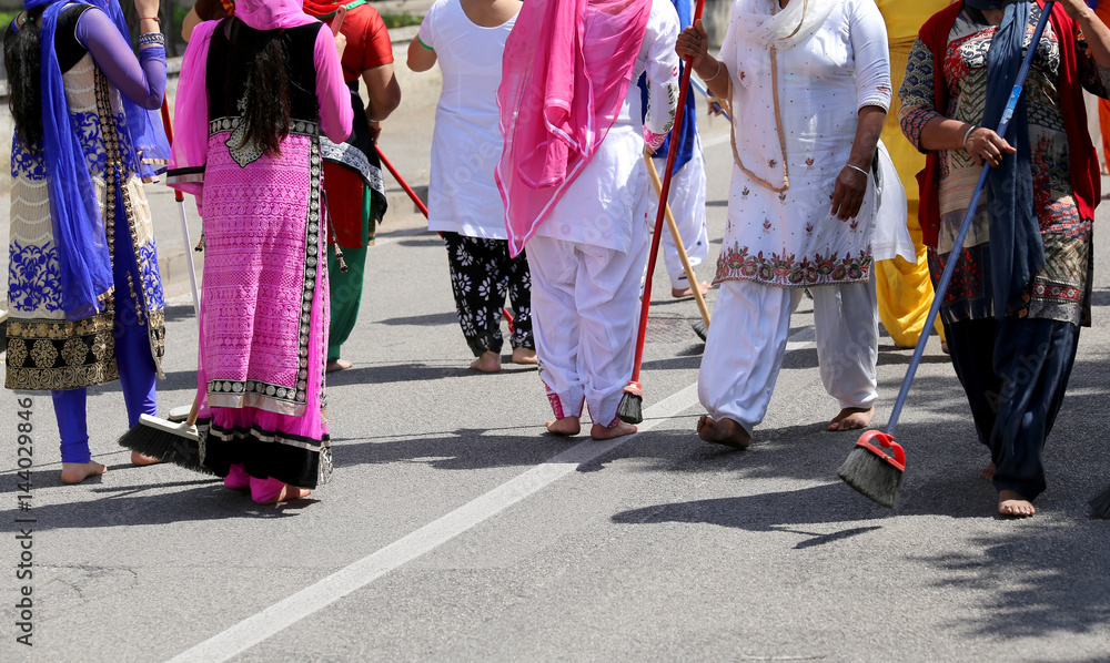 many Sikhs  women barefoot while scavenging the road during a Si
