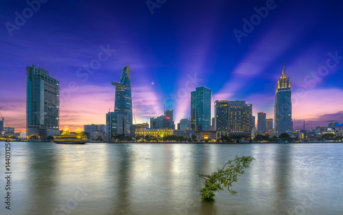 Ho Chi Minh City  Vietnam - March 25th  2017  Riverside City sunrays clouds in the sky at end of day brighter coal sparkling skyscrapers along beautiful river in Ho Chi Minh City  Vietnam