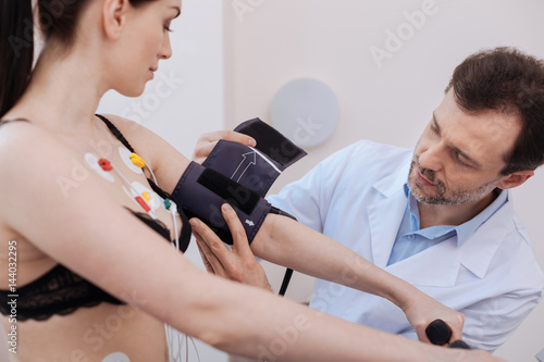 Patient attentive medical scholar using some equipment for comprehensive results