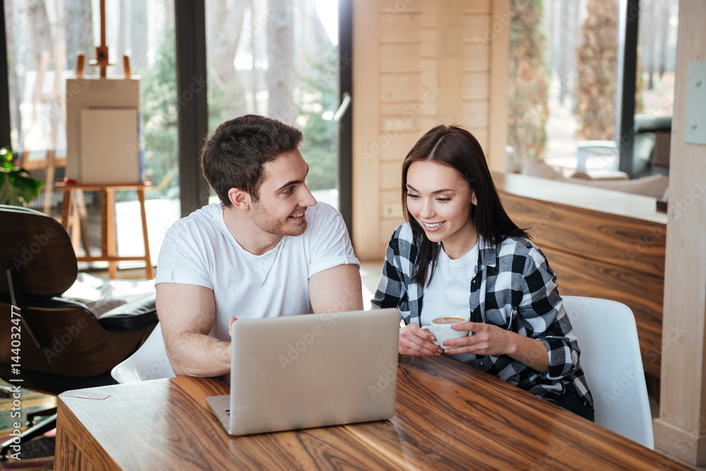 Using laptop and talking Using laptop and talking
