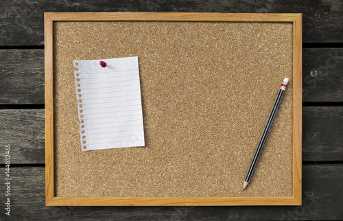 Fotografia, Obraz Blank memo pad and black pencil on brown cork board