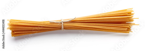 Whole grain spaghetti pasta isolated on white, from above