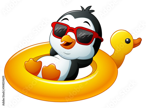 Cartoon penguin relaxing on the inflatable duck 