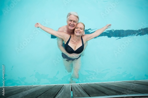 Fototapeta Naklejka Na Ścianę i Meble -  Mature couple swimming in pool