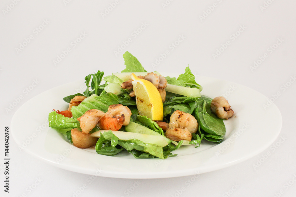 Sea salad with scallops, prawns, squid, cuttlefish, in duet with lettuce and cucumber, seasoned with olive oil and Provence herbs Sea salad with scallops, prawns, squid, cuttlefish, in duet with lettuce and cucumber, seasoned with olive oil and Provence herbs