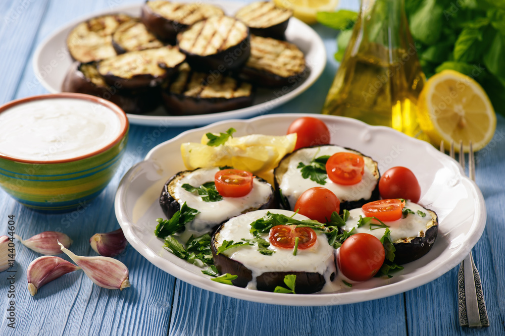 Grilled eggplants with yogurt dip and tomatoes. Grilled eggplants with yogurt dip and tomatoes.