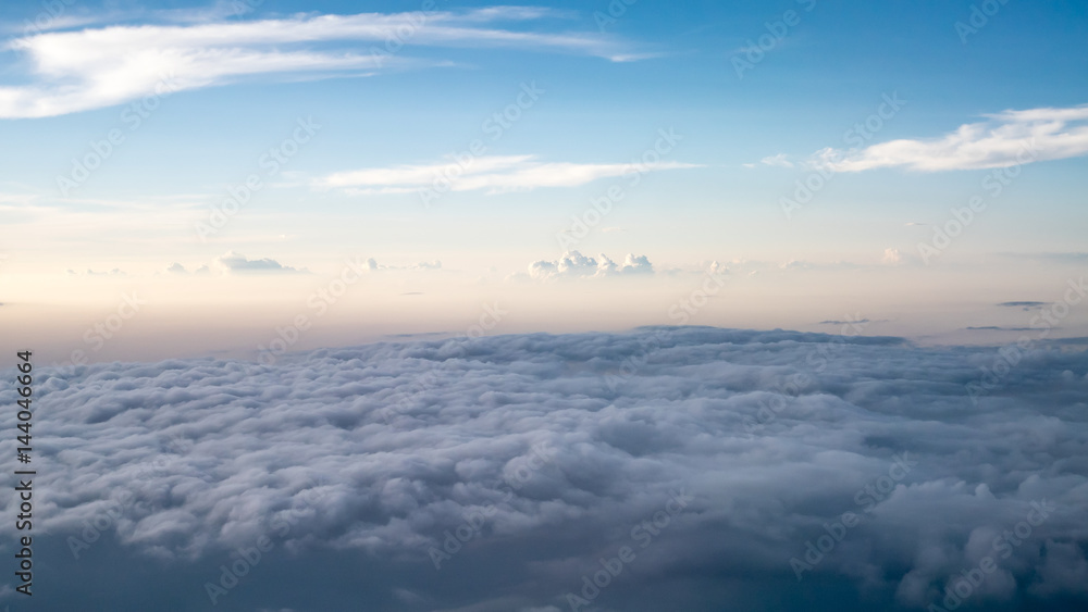 The beautiful cloudy and blue sky at early in the evening (view from airplane).