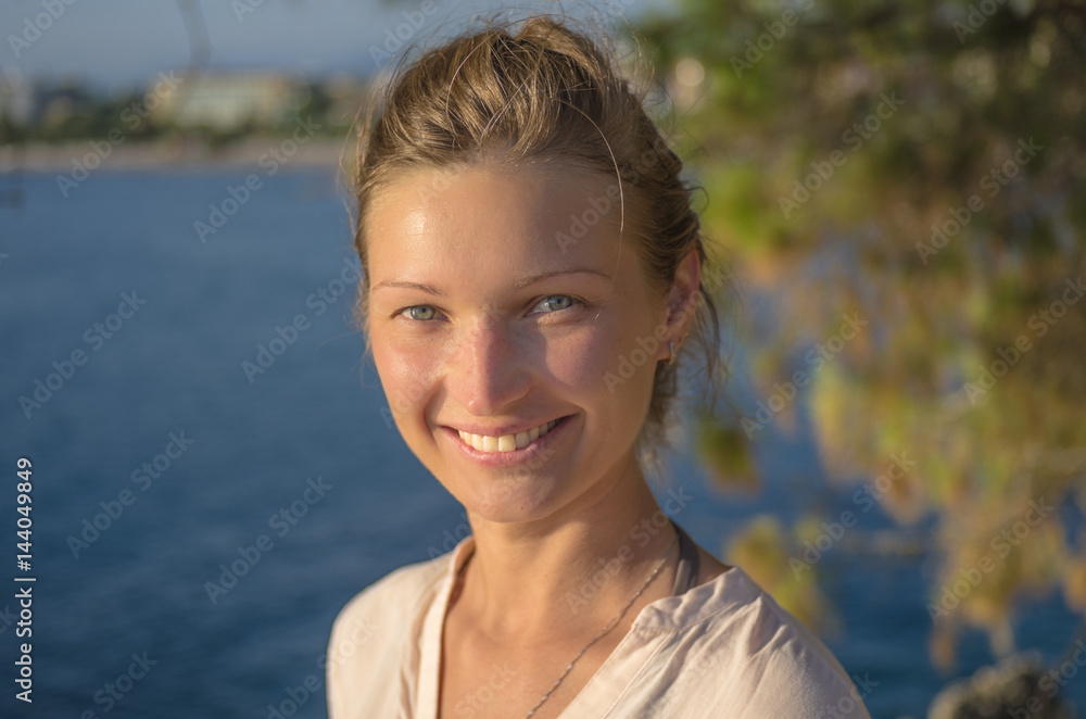 Portrait of an attractive smiling blonde woman at sunset Portrait of an attractive smiling blonde woman at sunset