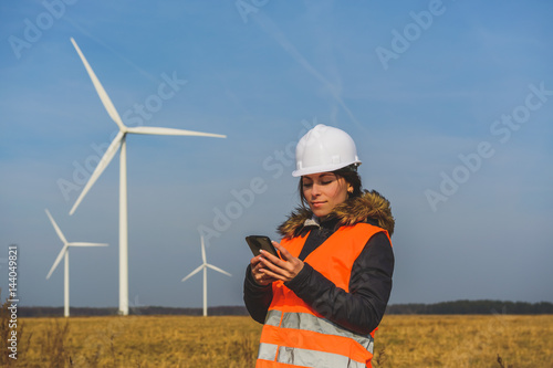 Young female specialist with smartphone