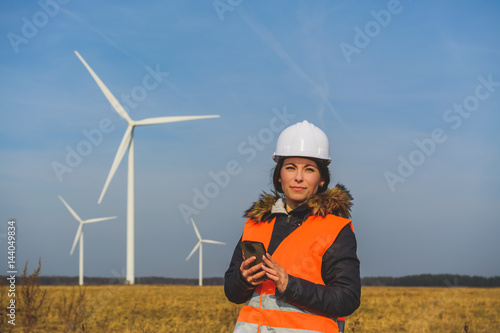 Young female specialist with smartphone