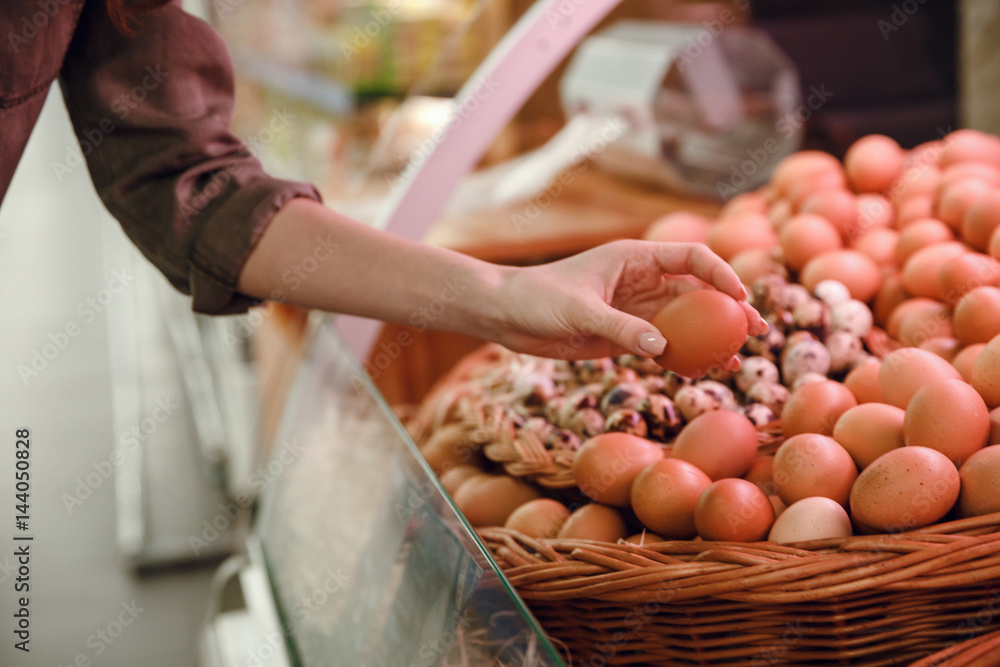 Cropped image of woman choosing eggs Cropped image of woman choosing eggs