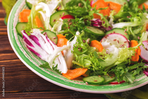 Fresh salad with salad mix, cucumber, radish and carrot