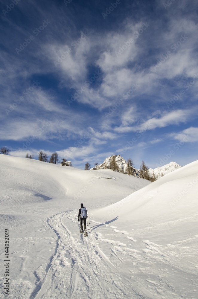 An hiker, alone, in the snow (Devero, Ossola, Piedmont) An hiker, alone, in the snow (Devero, Ossola, Piedmont)