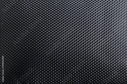 Black color of synthetic cloth texture close up photo show the detail of microfiber fabric texture surface background. 